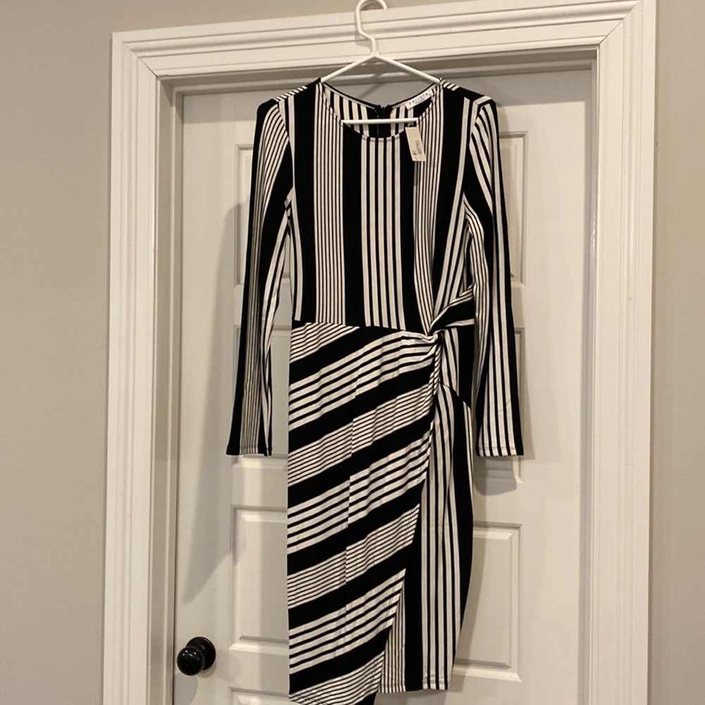 Fitted dress new with tags size large. Calista brand bought from boutique.